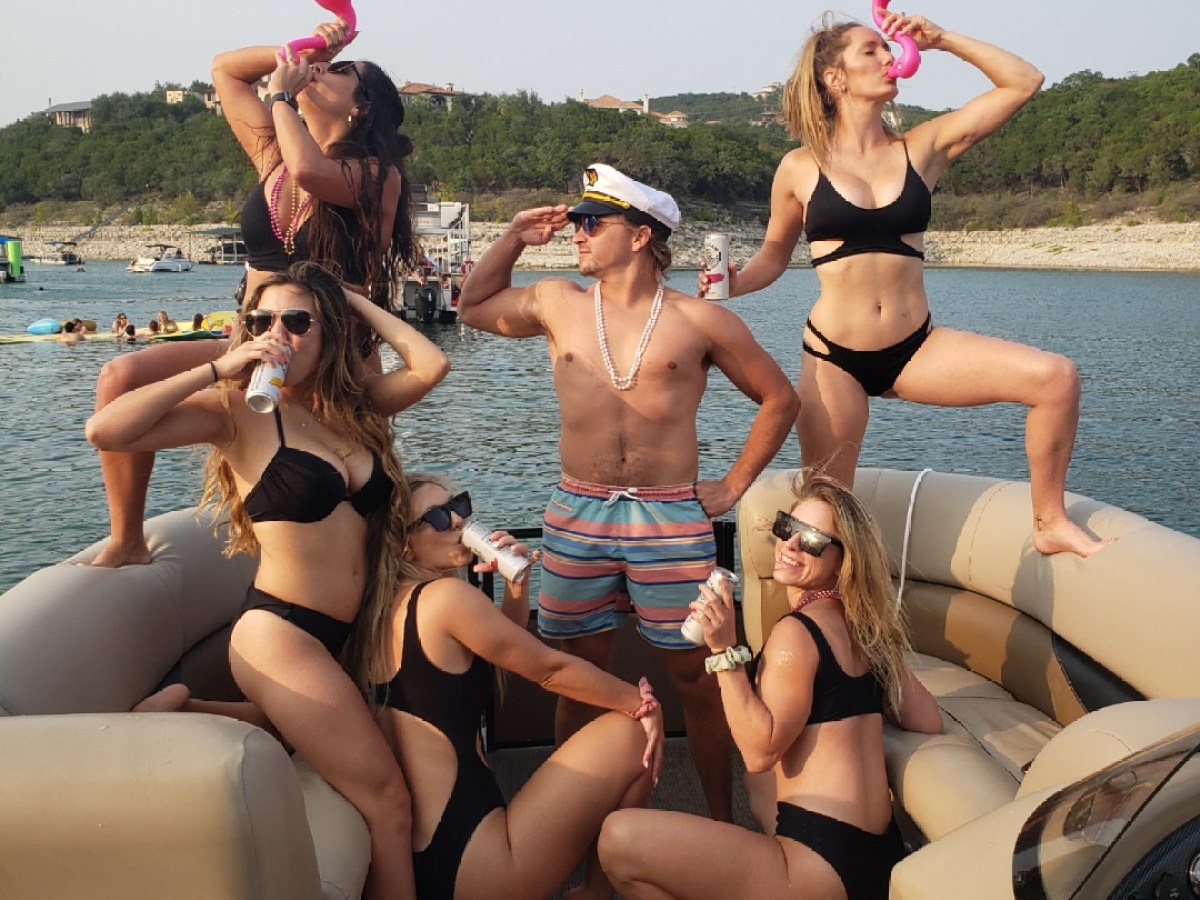 a woman sitting next to a body of water