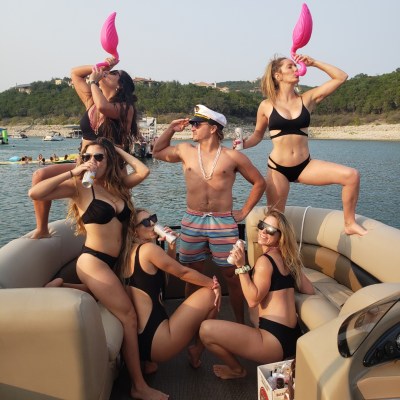 a woman sitting next to a body of water