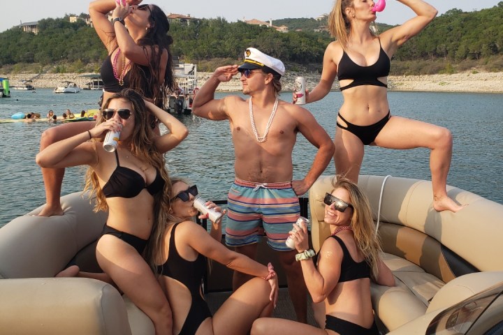 a woman sitting next to a body of water