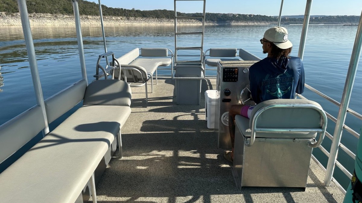 a person sitting on a chair in front of a body of water
