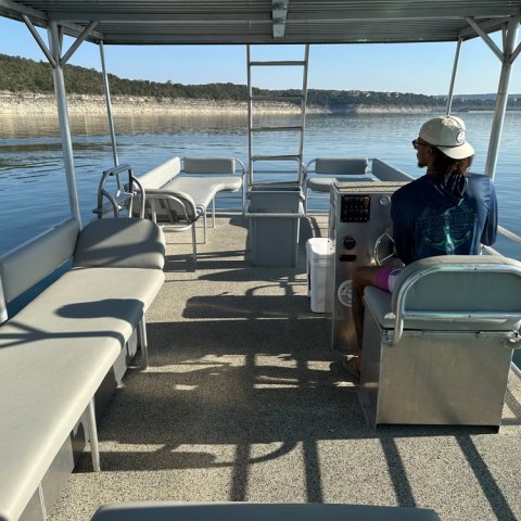 a person sitting on a chair in front of a body of water