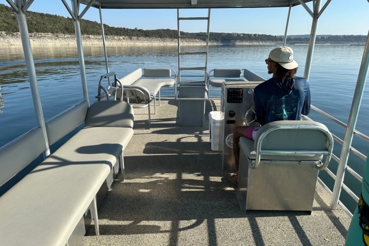 a person sitting on a chair in front of a body of water