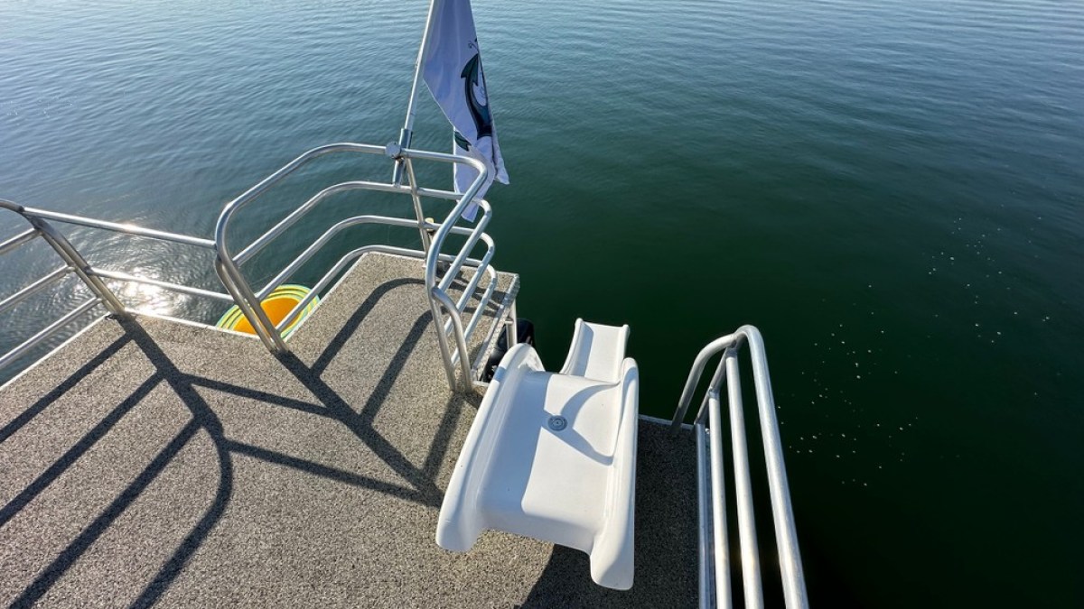 a chair sitting in front of a body of water