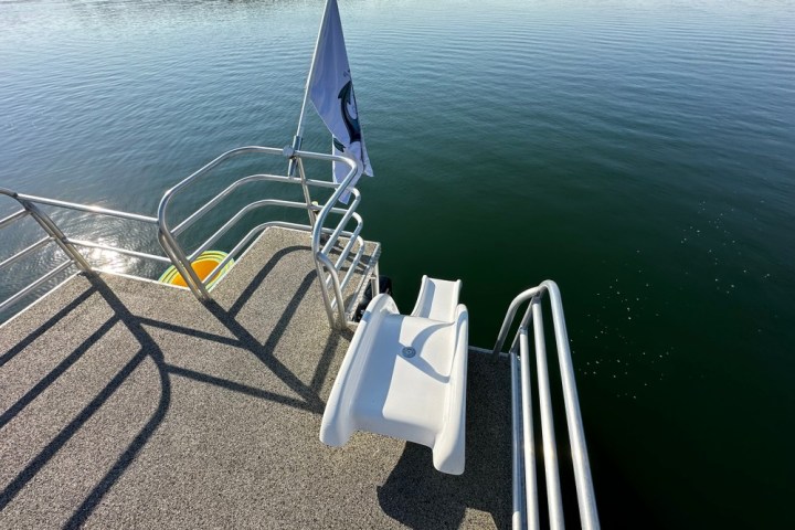 a chair sitting in front of a body of water