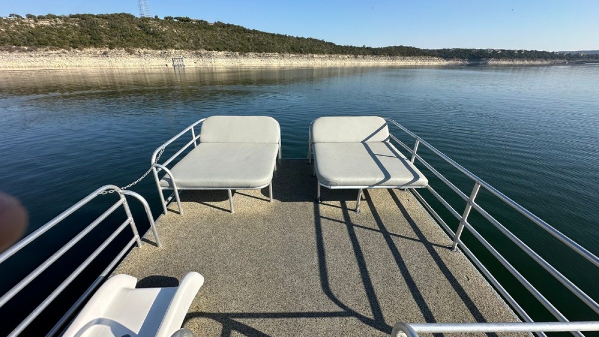 a person sitting on a bench next to a body of water