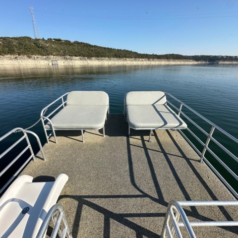 a person sitting on a bench next to a body of water