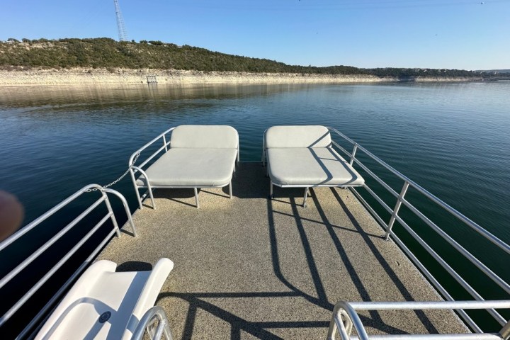 a person sitting on a bench next to a body of water