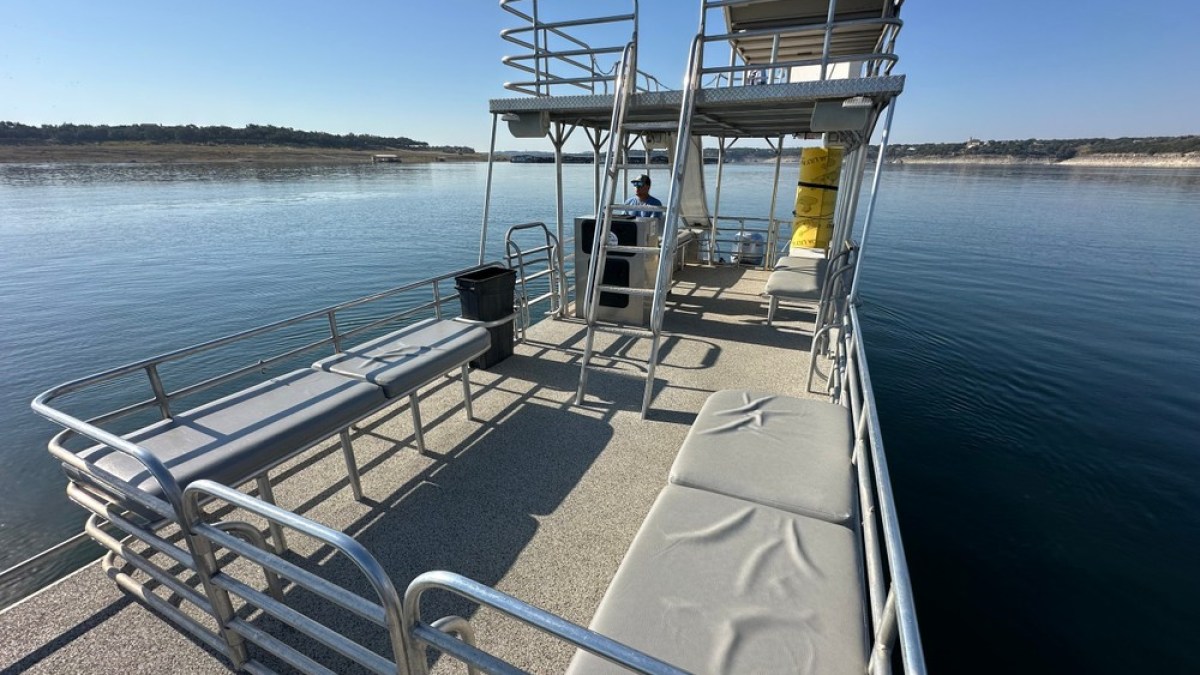 a boat that is sitting on a bench next to a body of water