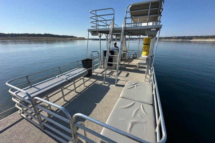 a boat that is sitting on a bench next to a body of water