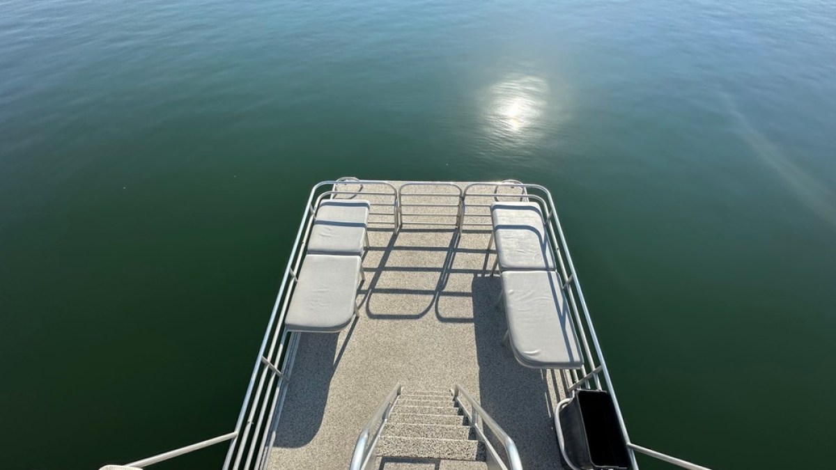 a boat that is sitting on a dock next to a body of water