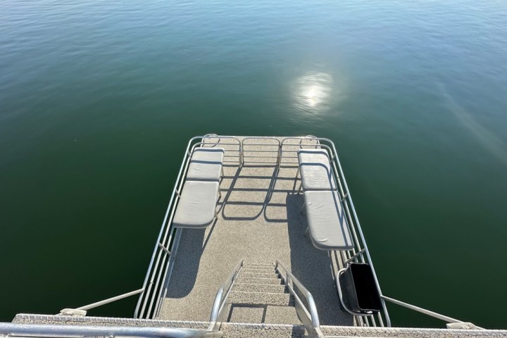 a boat that is sitting on a dock next to a body of water