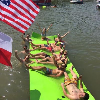 a group of people sitting in a boat on a body of water