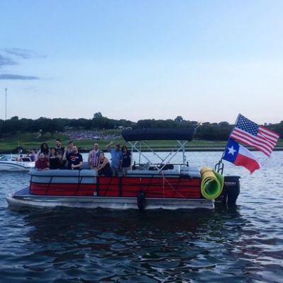 a group of people in a small boat in a body of water