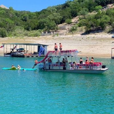 a group of people in a small boat in a body of water