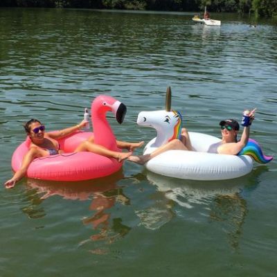 a group of people in a small boat in a body of water