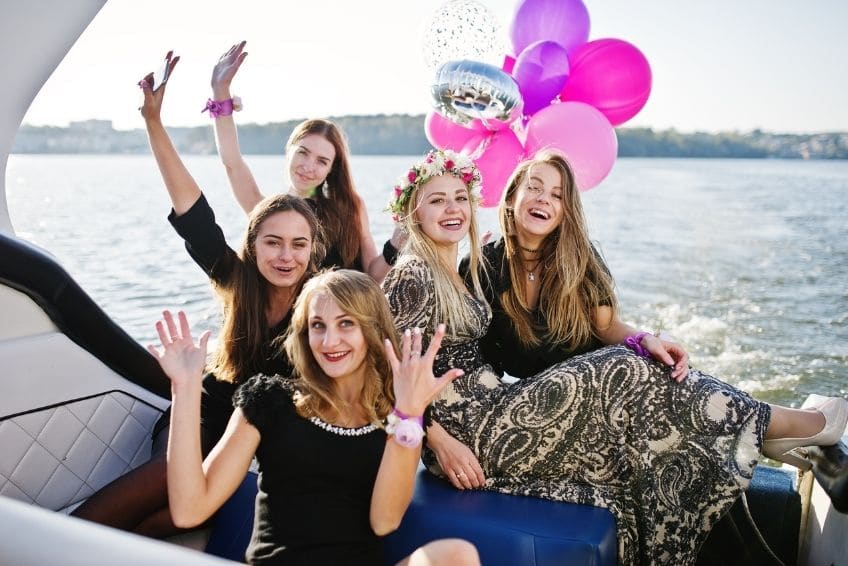 49rY946aUTEMcZL0hER2rhyqs72t3w5k1601300184-2 a group of people sitting in a boat on a body of water