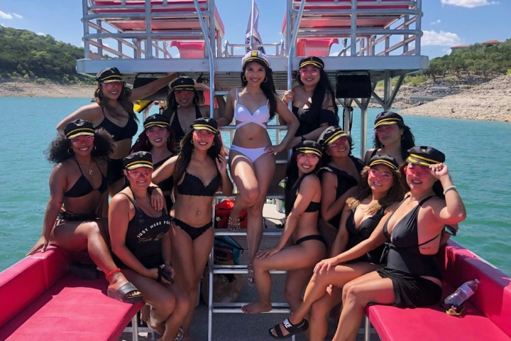 a group of people sitting in a boat on a body of water