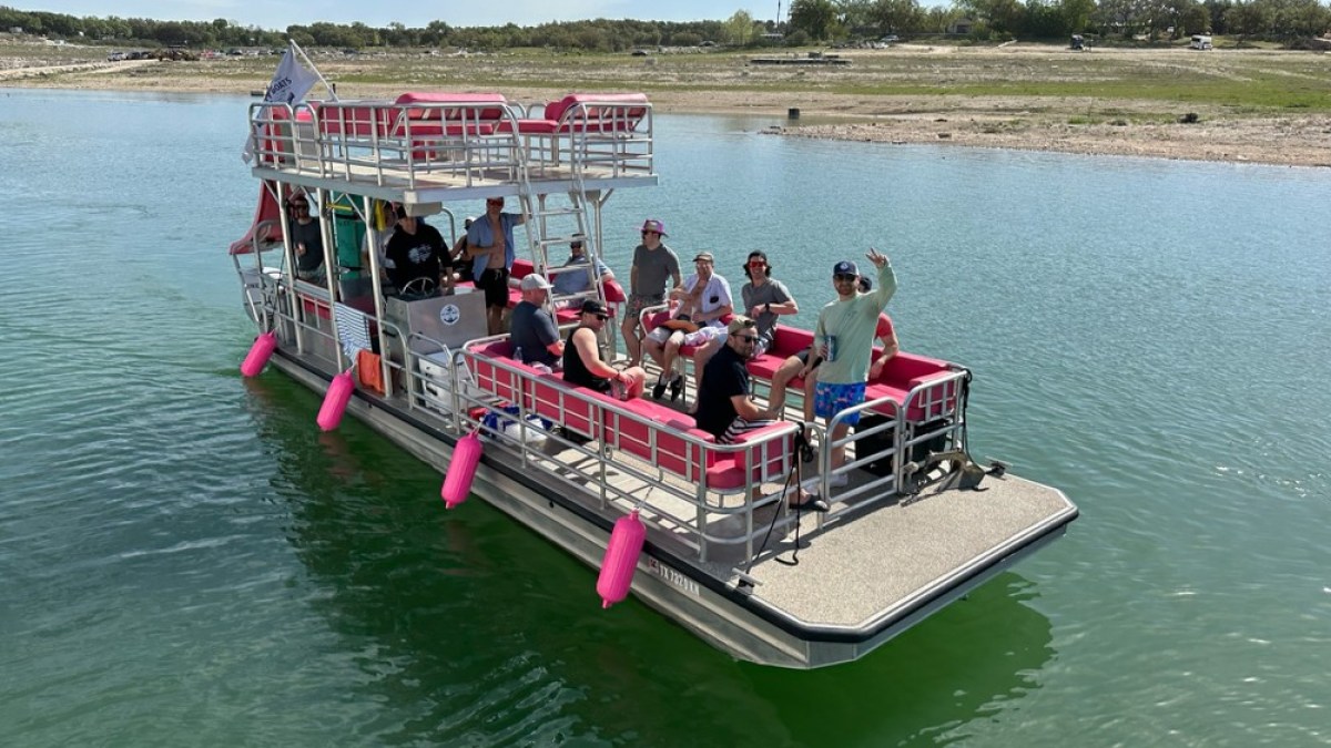 a group of people in a small boat in a body of water