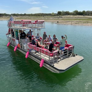 a group of people in a small boat in a body of water