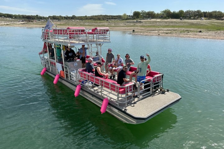 a group of people in a small boat in a body of water