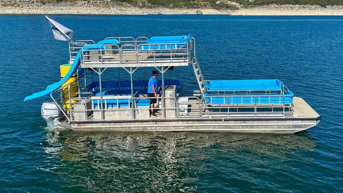 a blue and white boat floating on a body of water