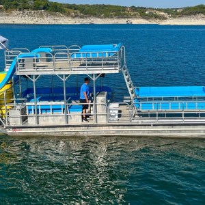 a blue and white boat floating on a body of water