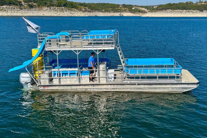 a blue and white boat floating on a body of water
