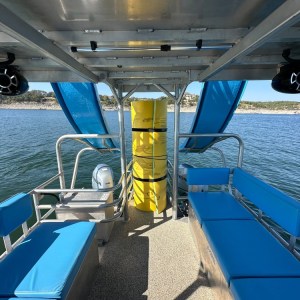a blue and white boat sitting next to a pool of water