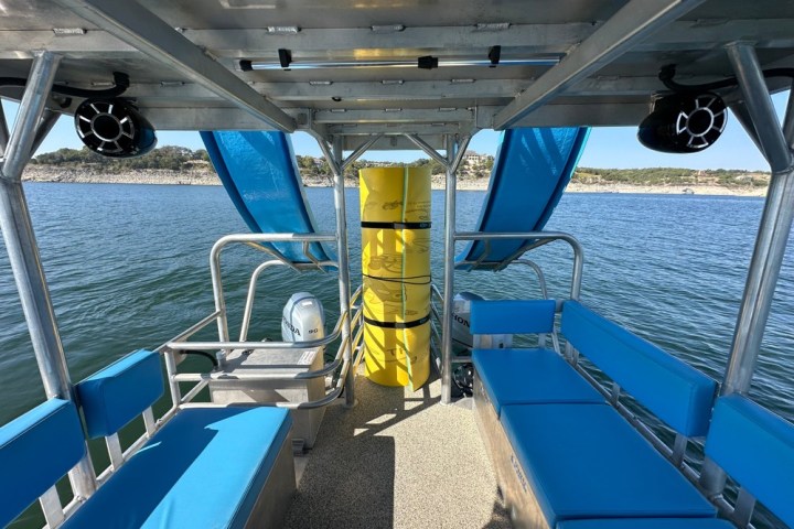 a blue and white boat sitting next to a pool of water