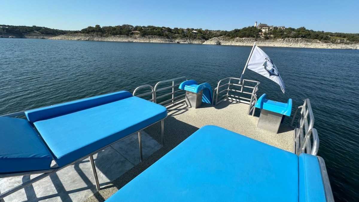 a blue chair next to a body of water