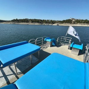 a blue chair next to a body of water