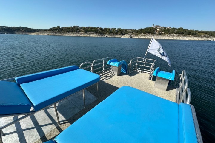 a blue chair next to a body of water
