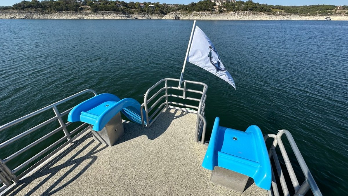 a blue bench in front of a body of water