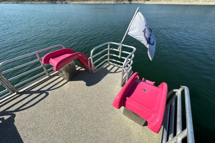 a chair sitting in front of a body of water