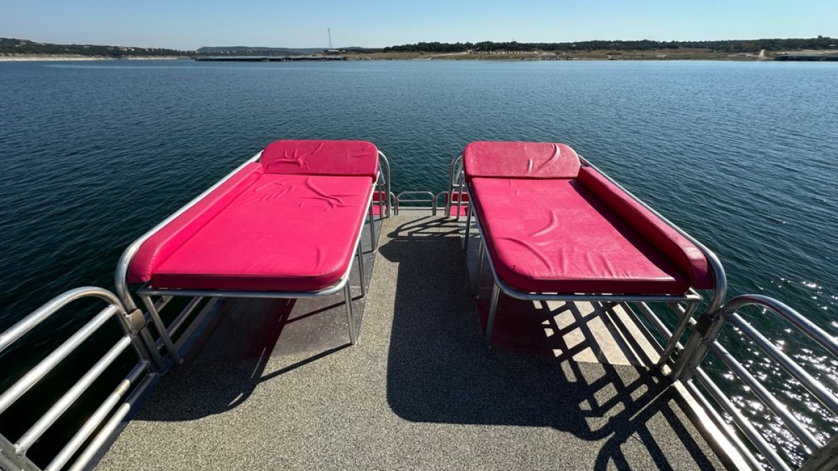a chair sitting in front of a body of water