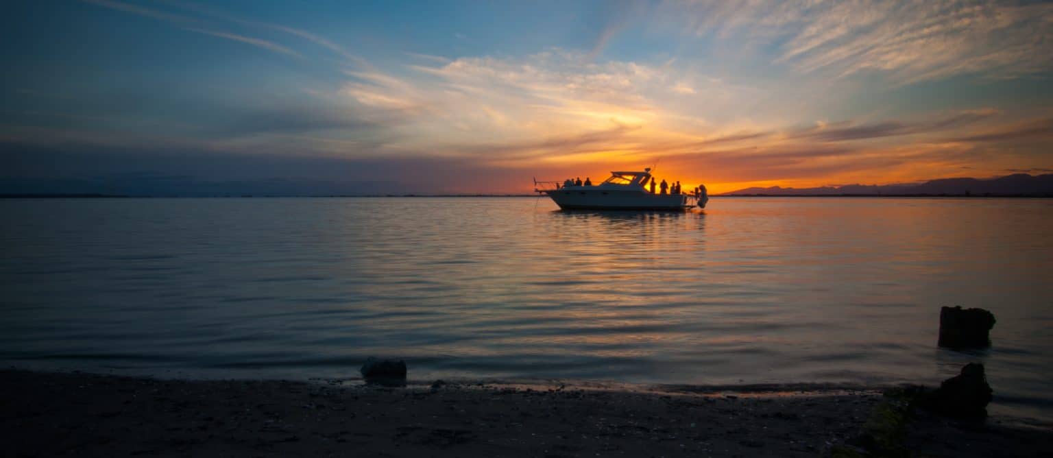 party-barge-1536×668 a sunset over a body of water