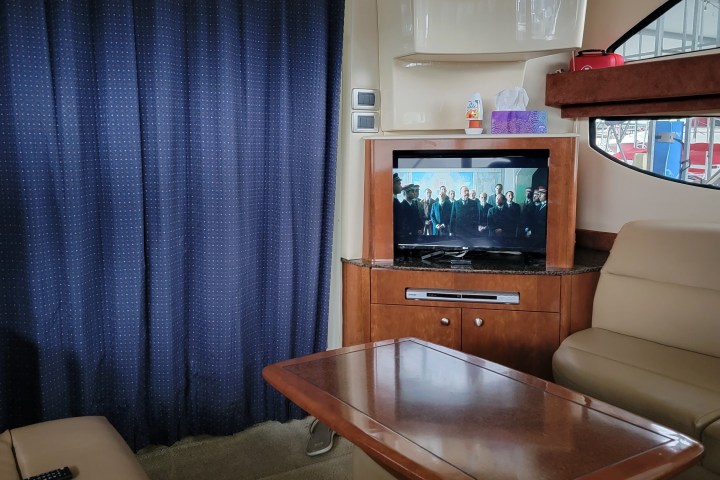 a desk with a computer and a chair in a room